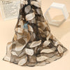 Elegant leaf pattern organza scarf in black, showcasing soft, lightweight fabric perfect for spring and summer outings.