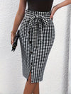 Chic houndstooth print bodycon skirt with button detail and tie waist, perfect for spring and fall fashion.