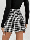 Elegant plaid skirt with button detail, showcasing stylish asymmetrical design for fall/winter women's fashion.