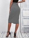 Chic houndstooth print skirt showcasing button detail and flattering tie waist, perfect for spring and fall fashion.