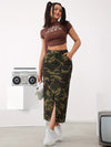 Fashionable camo denim midi skirt with slant pockets and side split, paired with a cropped brown top and sneakers.