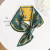 Elegant green and yellow silky scarf with floral pattern, a stylish accessory for women, perfect for spring and autumn.